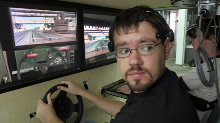 A guy training on a car simulator